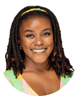 A young woman with dreadlocks and a colorful headband.
