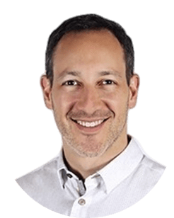 A man smiling in a white shirt.