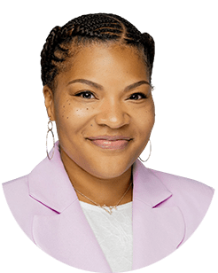 A smiling woman in a pink blazer.