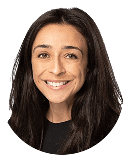 A woman with long hair smiling in a black shirt.