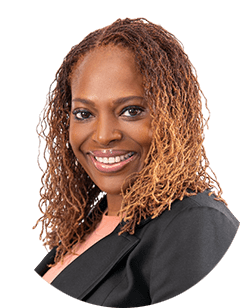 A smiling black woman with curly hair.