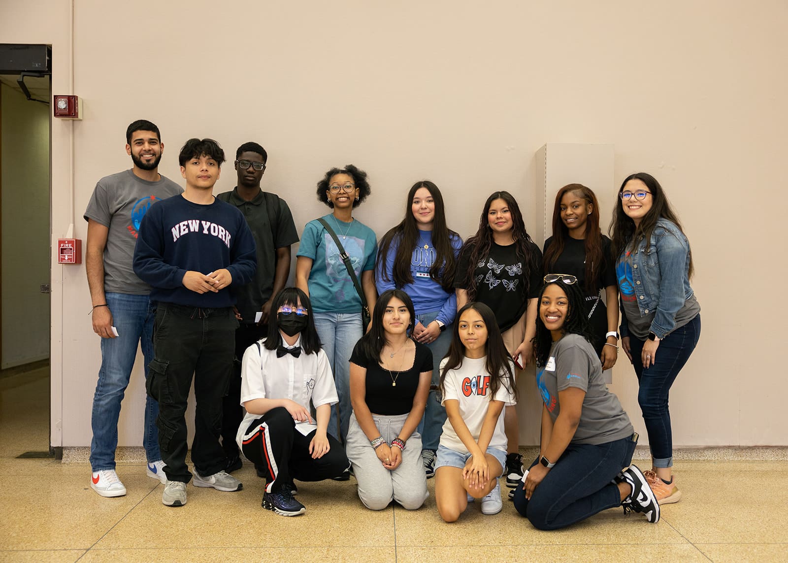 A group of people posing for a photo in a hallway.