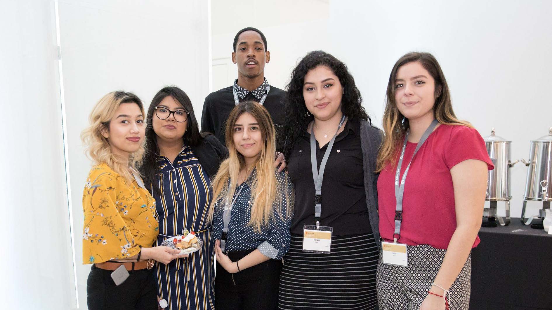 A group of people posing for a photo at an event.