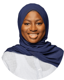 A person wearing a blue hijab and a light-colored shirt, smiling at the camera against a plain background.