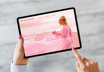 Woman building her website on tablet computer