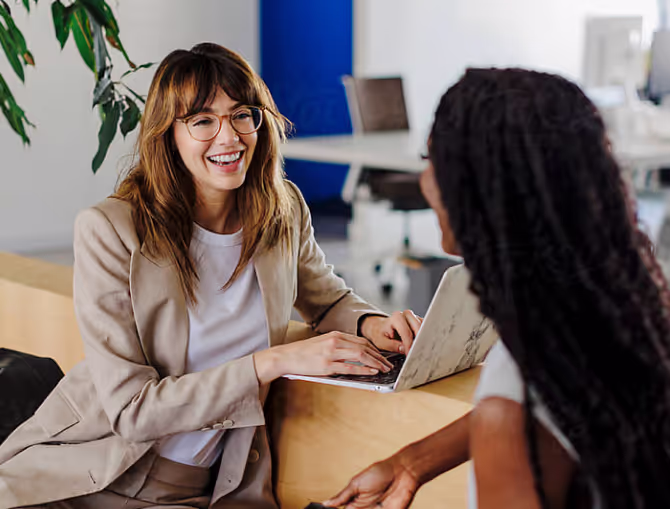 two women talking and smiling