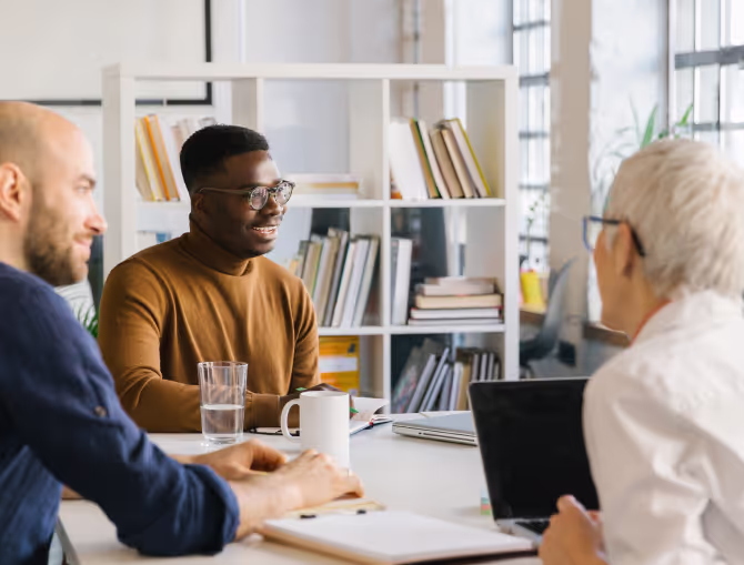 a group of business professionals talking around a table