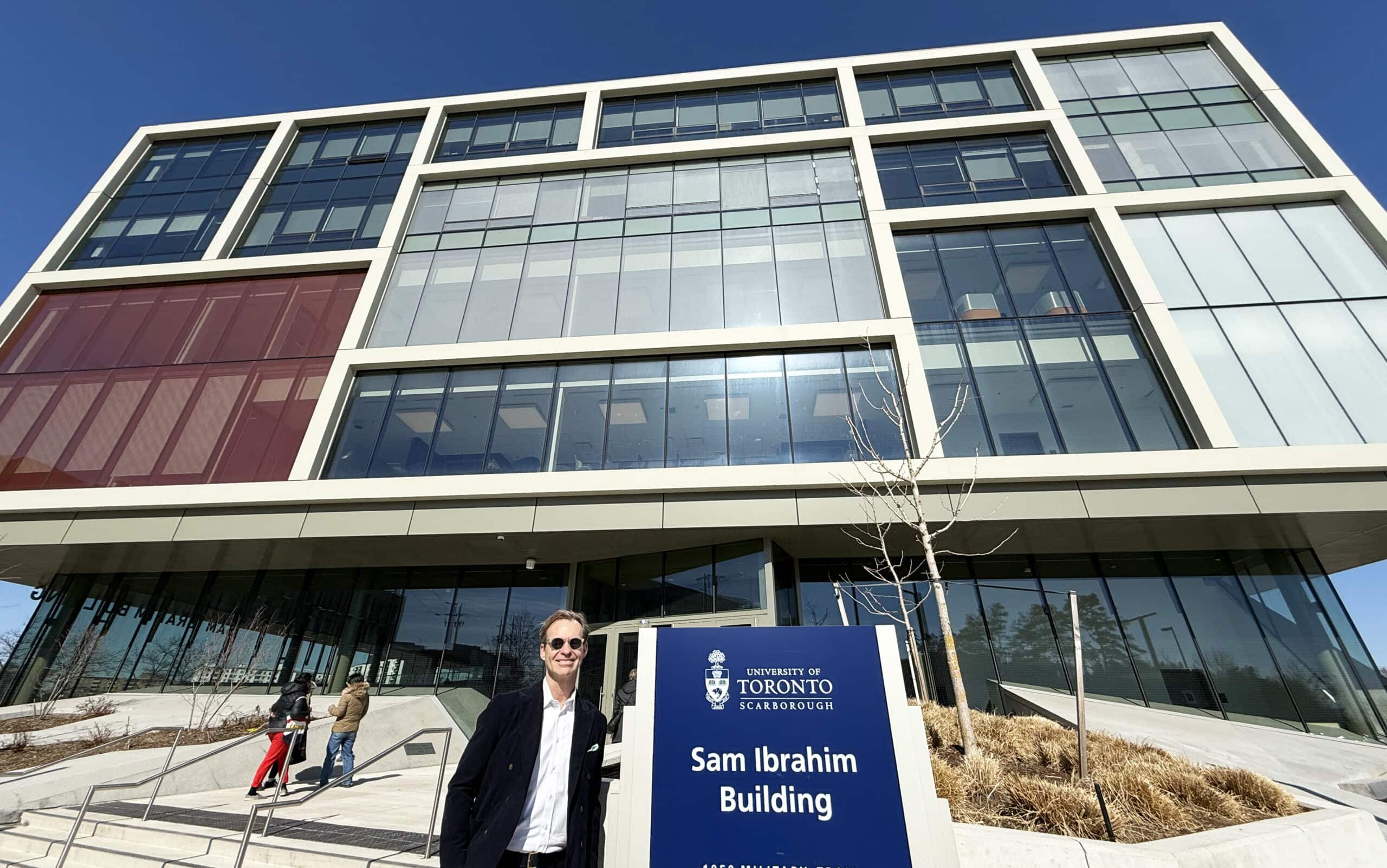 Man standing in front of the Sam Ibrahim building