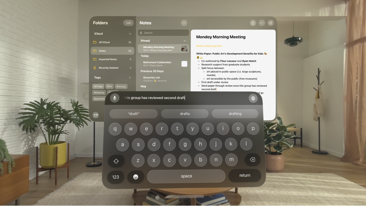 A user’s view on Apple Vision Pro. The Notes app is open, and a note is being edited with the virtual keyboard. The preview of the text being edited is visible at the top of the keyboard.