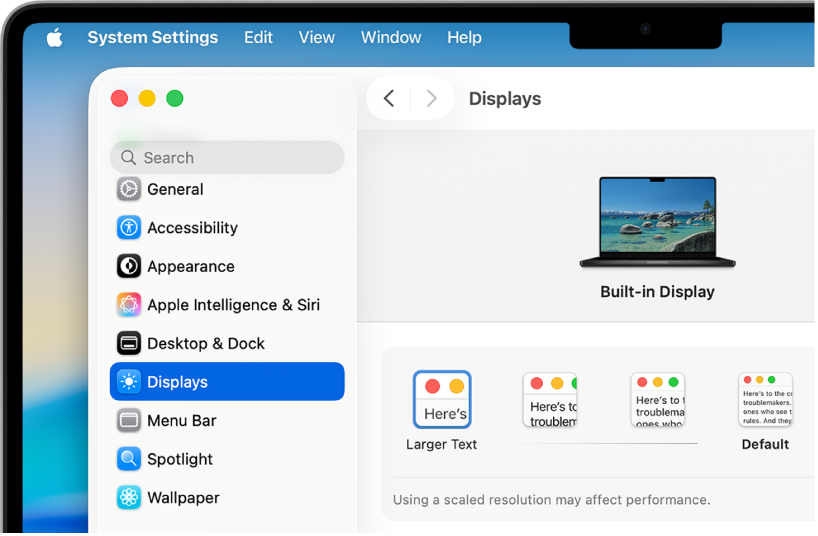 La fenêtre Réglages Système est ouverte sur le bureau. Le moniteur utilise une résolution inférieure pour que les éléments de l’interface utilisateur apparaissent plus grands.