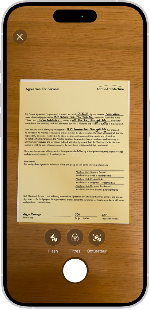 Un écran affichant un document en cours de numérisation. Le bouton de prise de photo est situé en bas au centre.