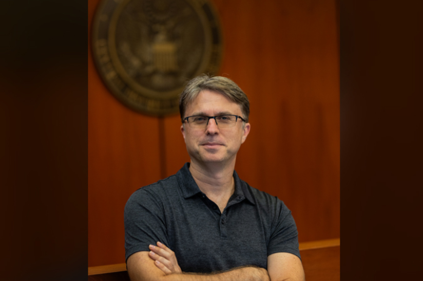 Professor Adam Zimmerman in front of the USC seal