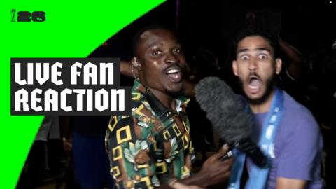 Cape Verde fan cheers while being interviewed by reporter Paul Ngie