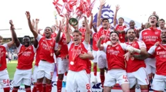 The Arsenal squad celebrate with the Premier League trophy