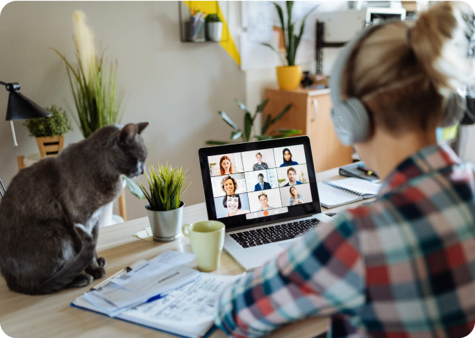 Woman on a conference call with her cat sitting next to her