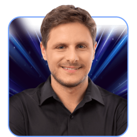 Smiling man in black shirt with blue background.