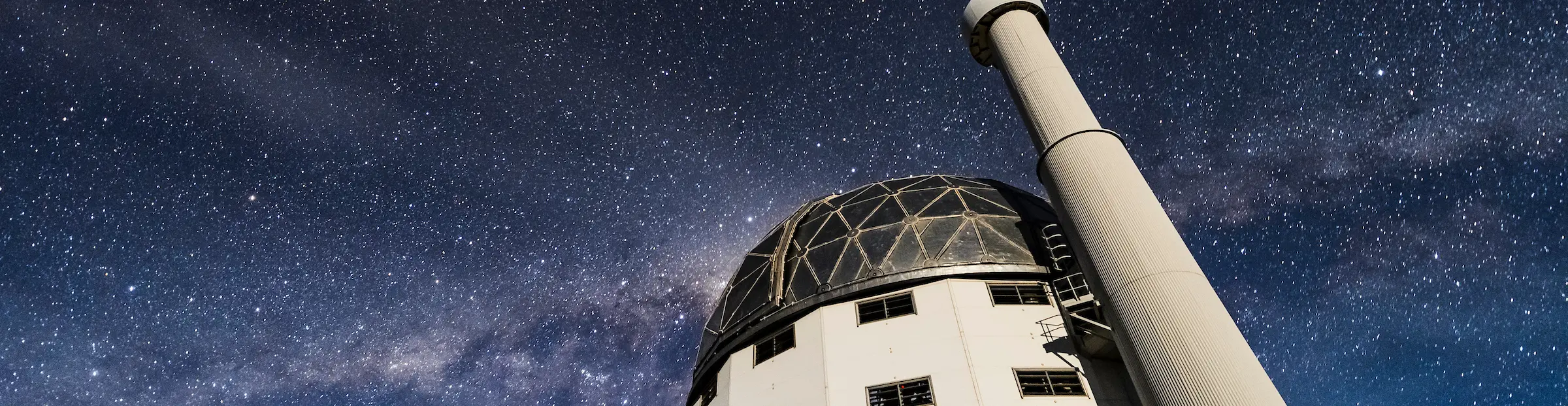 The Southern African Large Telescope under a starry sky with a visible Milky Way.