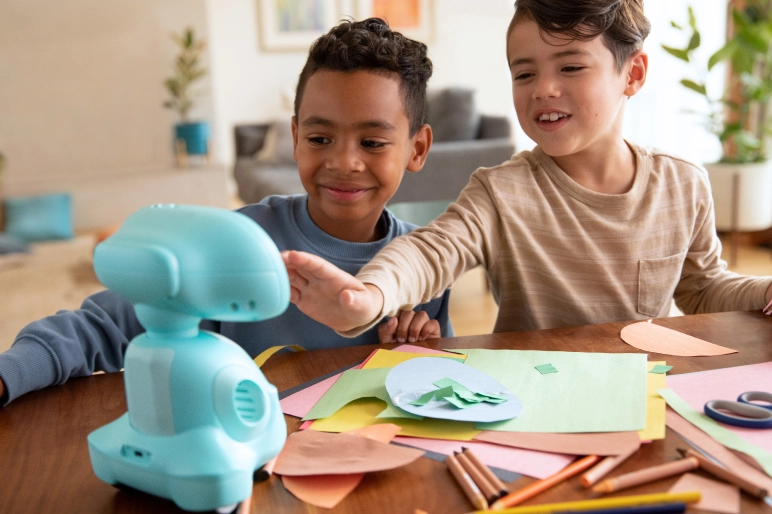 Two boys playing with Miko robot